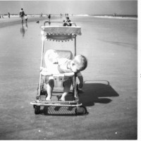 child on beach in stroller