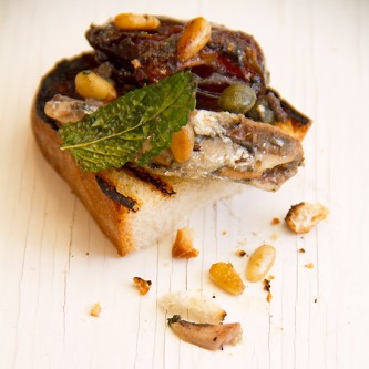 White anchovies with dates and capers on toast