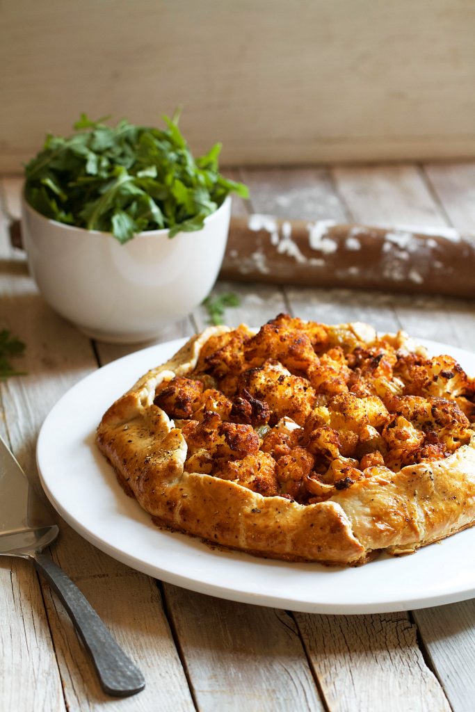 Cauliflower Galette with Labneh, Harissa, and Pickled Raisins