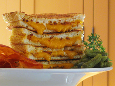 Grilled cheddar cheese sandwich with prosciutto chips