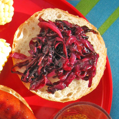 pickled red cabbage on barbequed sausage sandwich